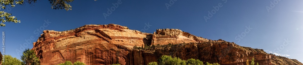 Fototapeta premium Panorama shot of red sriped sandstone mountain in Capitol Reef national park in Utha, America