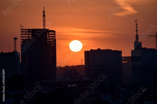 Silhouette of city center with construction on going and the  sun set