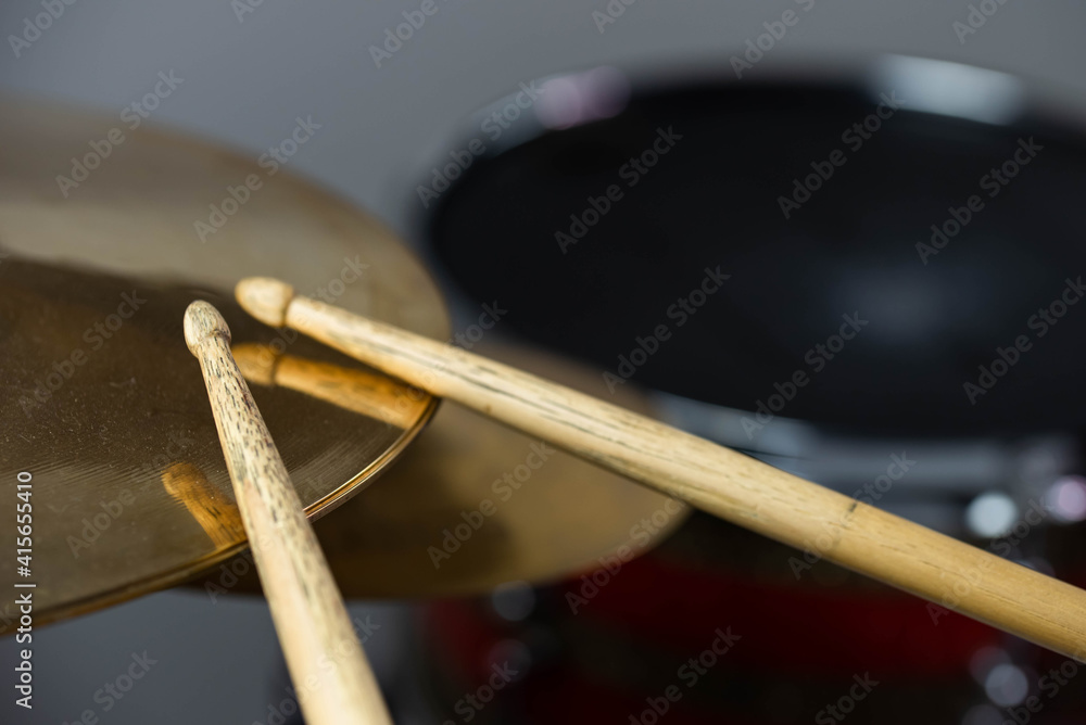Professional drum set closeup. Man drummer with drumsticks playing drums and cymbals, on the live music rock concert or in recording studio Professional drum set closeup. Man drummer with drumsticks playing drums and cymbals, on the live music rock concert or in recording studio