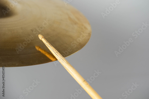 Professional drum set closeup. Man drummer with drumsticks playing drums and cymbals, on the live music rock concert or in recording studio   