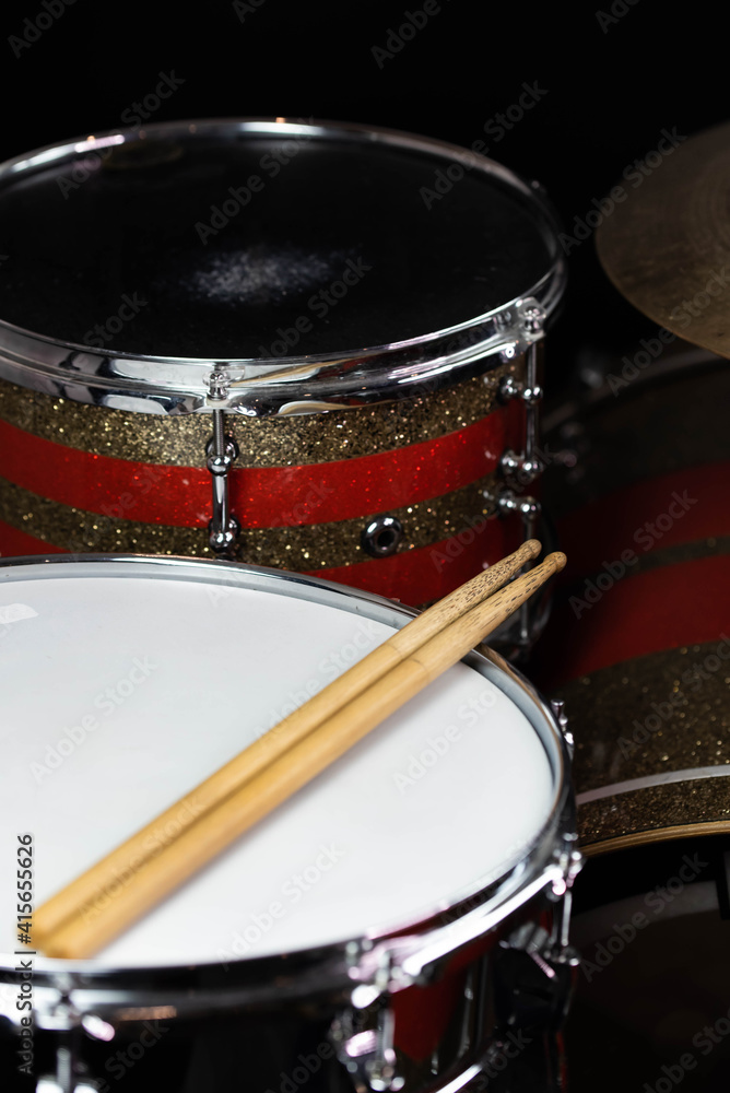 Closeup of drumsticks lying on the professional drum set. Drummer equipment. Closeup of drumsticks lying on the professional drum set. Drummer equipment.