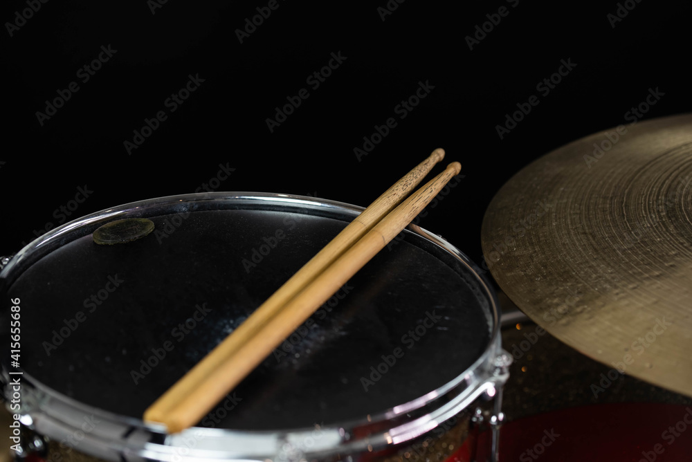 Closeup of drumsticks lying on the professional drum set. Drummer equipment. Closeup of drumsticks lying on the professional drum set. Drummer equipment.