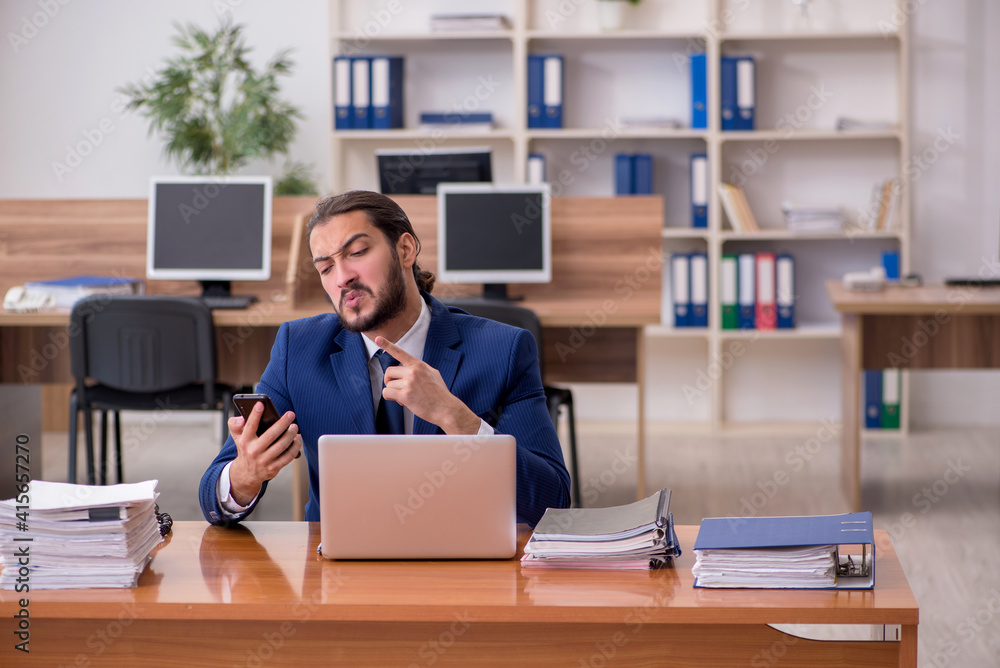 Young businessman employee working at workplace Young businessman employee working at workplace