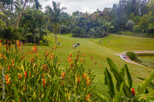 Photography SINGAPORE, SINGAPORE - MARCH 11, 2018: People on a lawn in Singapore Botanic Gardens