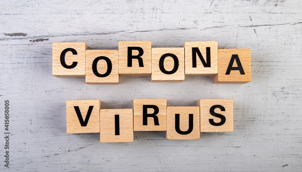 Obraz premium wooden blocks in a white and grey board with the text corona virus