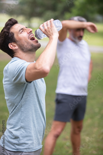 fitness man drinking water from bottle