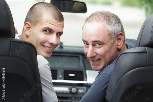 dad and son looking back and smiling