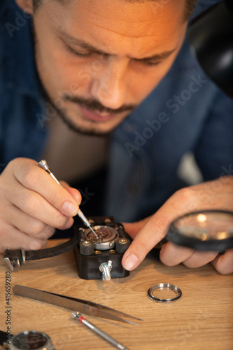 a man repairing a watch