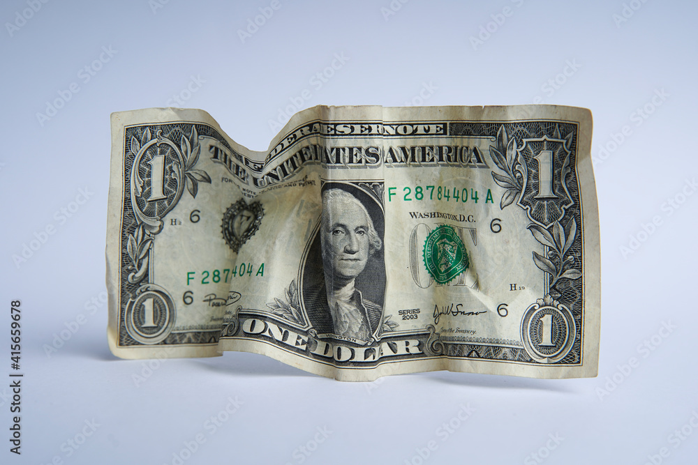 Financial crisis, crumpled one dollar banknote, US dollars on the white table. Bank image and commercial photo background. Financial crisis, crumpled one dollar banknote, US dollars on the white table. Bank image and commercial photo background.
