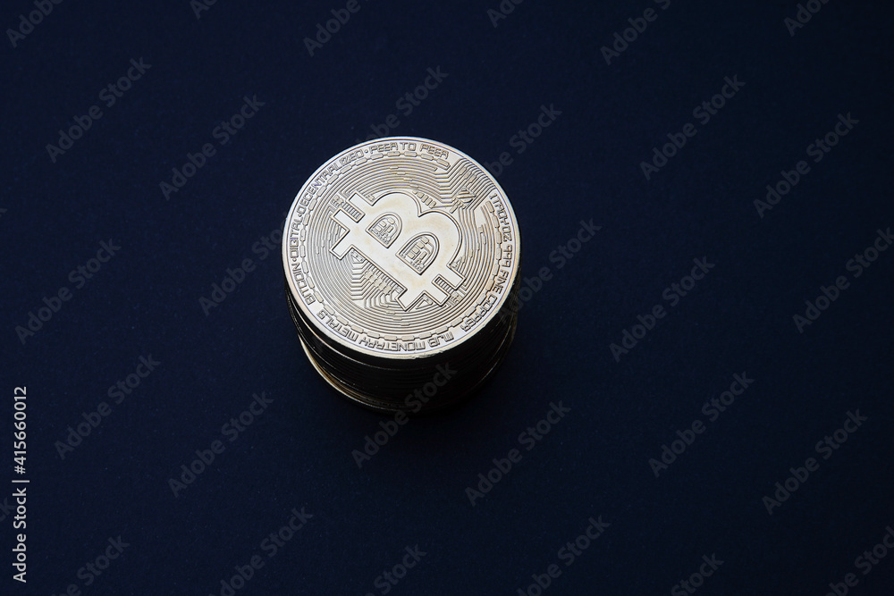 Stacked gold Bitcoin cryptocurrency (BTG). Coins on a dark background. Blockchain technology, Crypto currency, digital money. Stacked gold Bitcoin cryptocurrency (BTG). Coins on a dark background. Blockchain technology, Crypto currency, digital money.