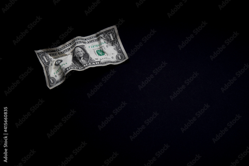Financial crisis, crumpled one dollar banknote, US dollars on the black table. Bank image and commercial photo background. Financial crisis, crumpled one dollar banknote, US dollars on the black table. Bank image and commercial photo background.