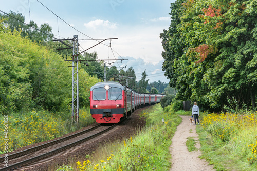 Passenger train moves at autumn day time.