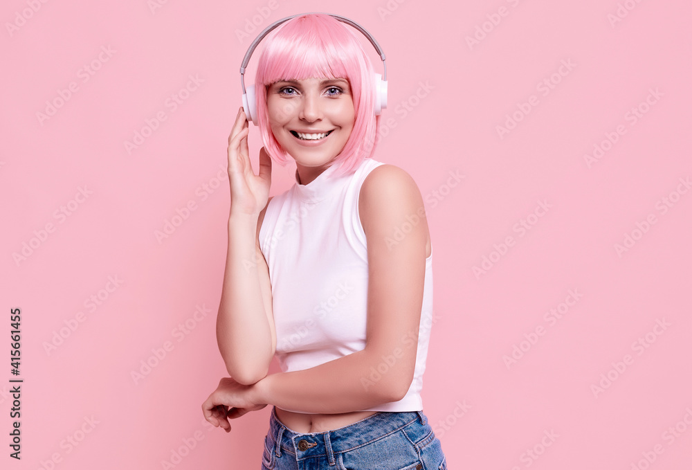 Bright sexy hipster girl with pink hair enjoys the music in headphones Bright sexy hipster girl with pink hair enjoys the music in headphones