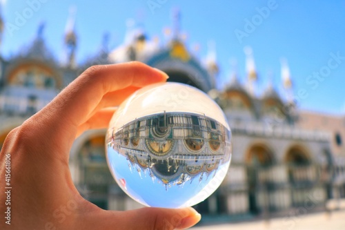 hand holding globe or lens ball in little Venice 