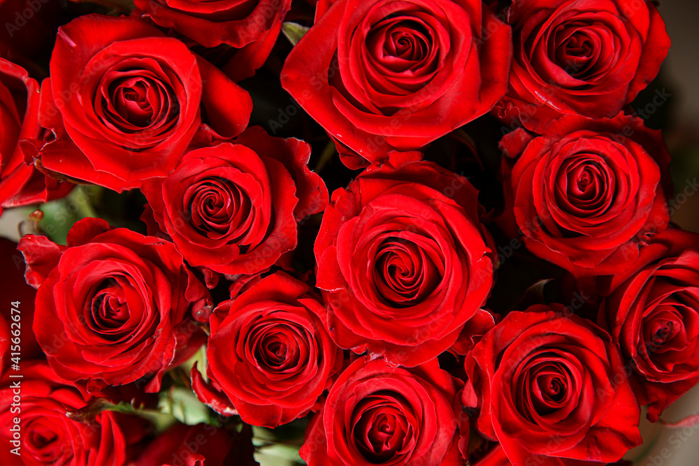 Beautiful bouquet of red roses, seen from above. Spring flowers. Wedding, women's day, mothers day and valentines day background. Selective shallow depth of field. Beautiful bouquet of red roses, seen from above. Spring flowers. Wedding, women's day, mothers day and valentines day background. Selective shallow depth of field.