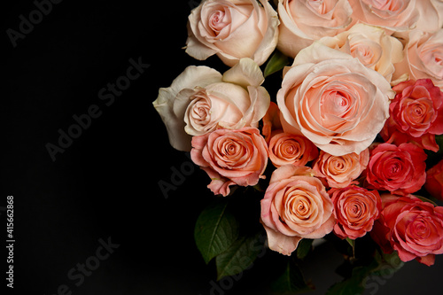 Beautiful white  red  tabby tea rose flowers in a vase  photographed from above on a black table. Spring flowers. Wedding  mother s day and valentines day background. Selective  small depth of field.