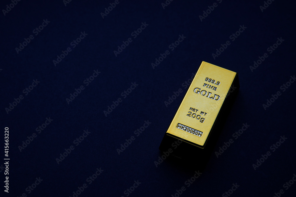 three gold bars on a bluish background. Shiny precious metals for investments or reserves. Place for text. three gold bars on a bluish background. Shiny precious metals for investments or reserves. Place for text.
