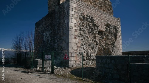 Old stone tower and defensive thick walls, Smlednik castle, Slovenia. Ruined middle ages fortress. Ruins of renovated old tower. Tourist attraction. Tilt up, wide angle photo