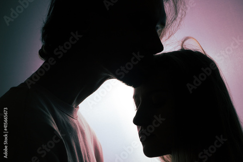 portrait of a romantic couple when illuminated from a window or door.