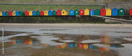 Beach huts reflected in puddles, Whitby Beach