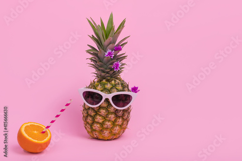  Female pineapple hipster in sunglasses with  fresh orange juice