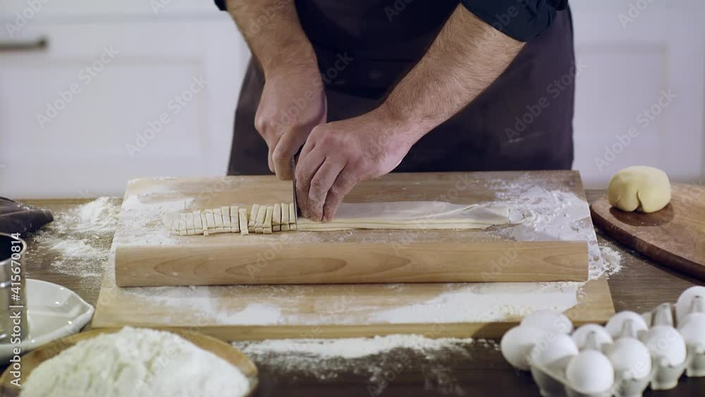 Close-up of pasta dough. The chef is slicing the spaghetti. Close-up of pasta dough. The chef is slicing the spaghetti.