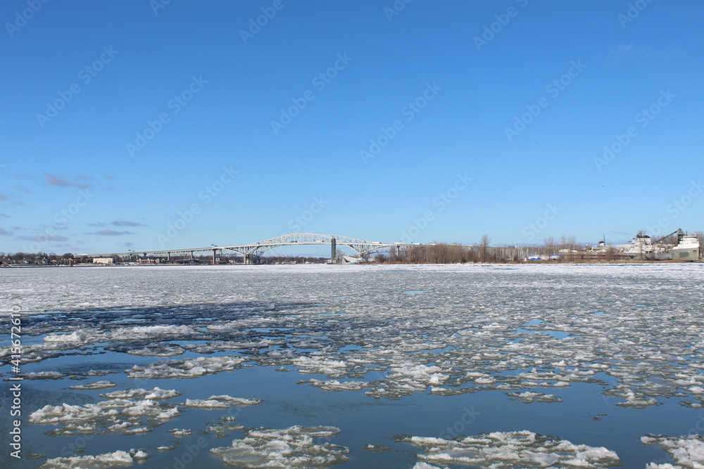 Icy St. Clair River from Port Huron, Michigan with the Blue Water Bridge and Point Edward, Canada in the background