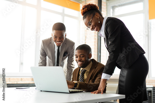 team of young african people in office at table with laptop 