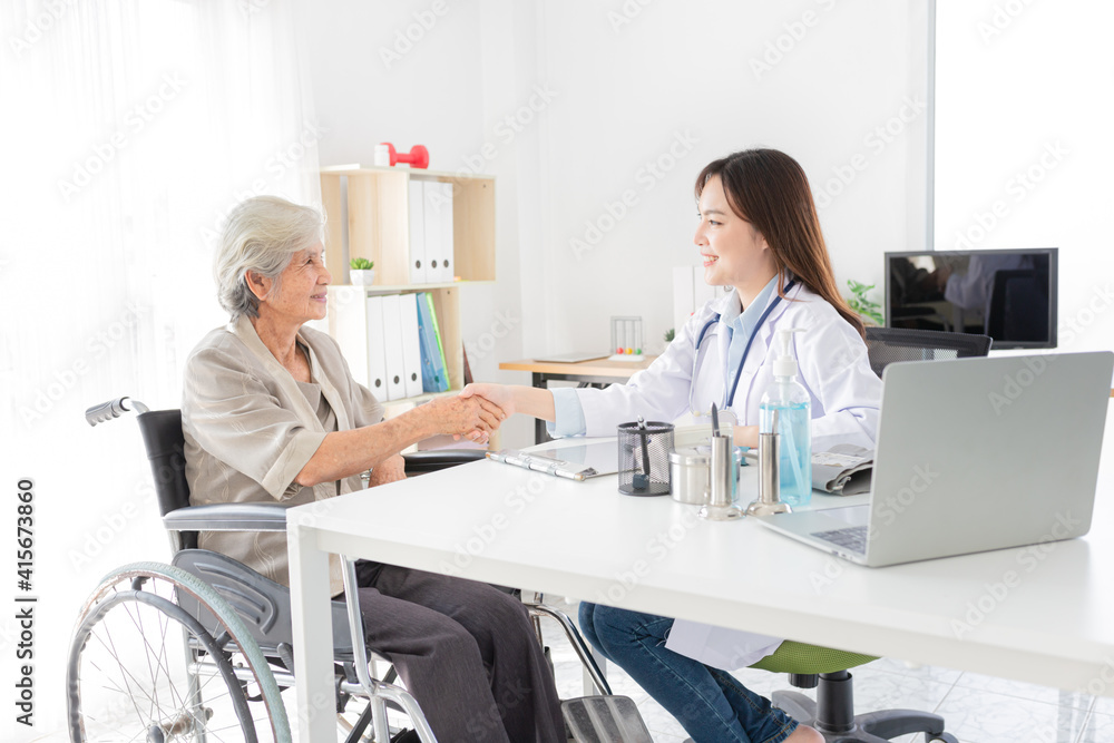 Asian doctor talk with old female patient about disease symptom, they holding hand together, elderly health check up, happiness hospital, hand in hand Asian doctor talk with old female patient about disease symptom, they holding hand together, elderly health check up, happiness hospital, hand in hand