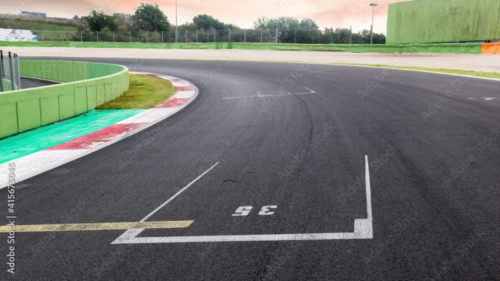 Motorsport background curve and curb asphalt track empty competition car circuit no people, scenic sunrise landscape sky Motorsport background curve and curb asphalt track empty competition car circuit no people, scenic sunrise landscape sky