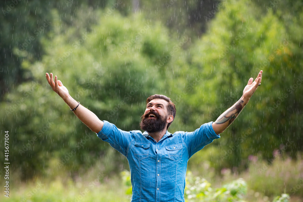 Relaxation and positive thinking. Stormy weather. Bearded man under rain. Autumn rain.