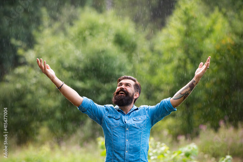 Relaxation and positive thinking. Stormy weather. Bearded man under rain. Autumn rain.