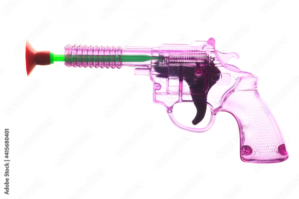 A child toy plastic gun on a white backdrop A child toy plastic gun on a white backdrop