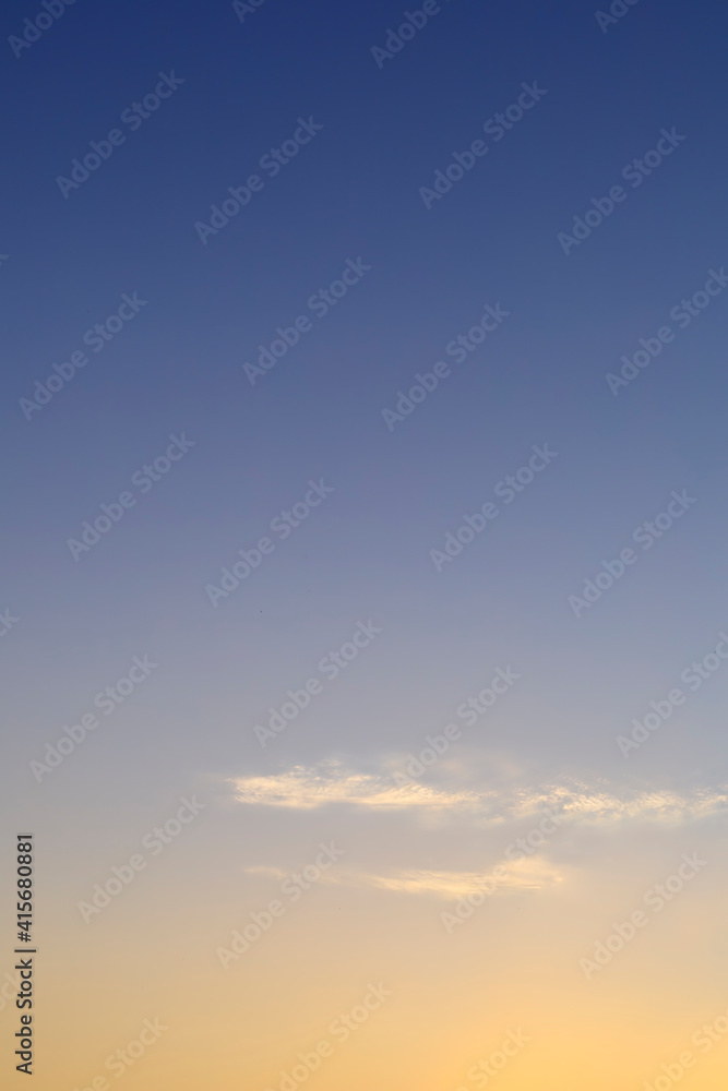 Beautiful morning clear sky background. Colorful yellow blue sky. Morning colorful clear blue sky background with soft white clouds sunrise or sunset.