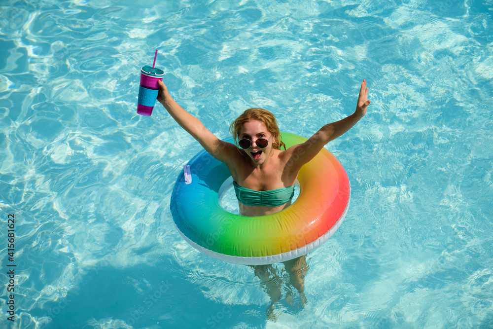 Girl swimming pool. Summer vacation. Woman in swimsuit on inflatable circle in the swimmingpool.