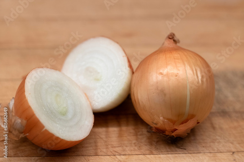 White onions whole and cut  on a wooden board