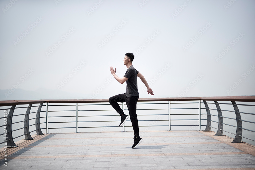 asian young man exercising outdoors