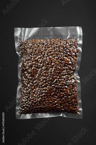 Obraz na plátně fresh roasted coffee beans packed in vacuum sealed bag, gray background