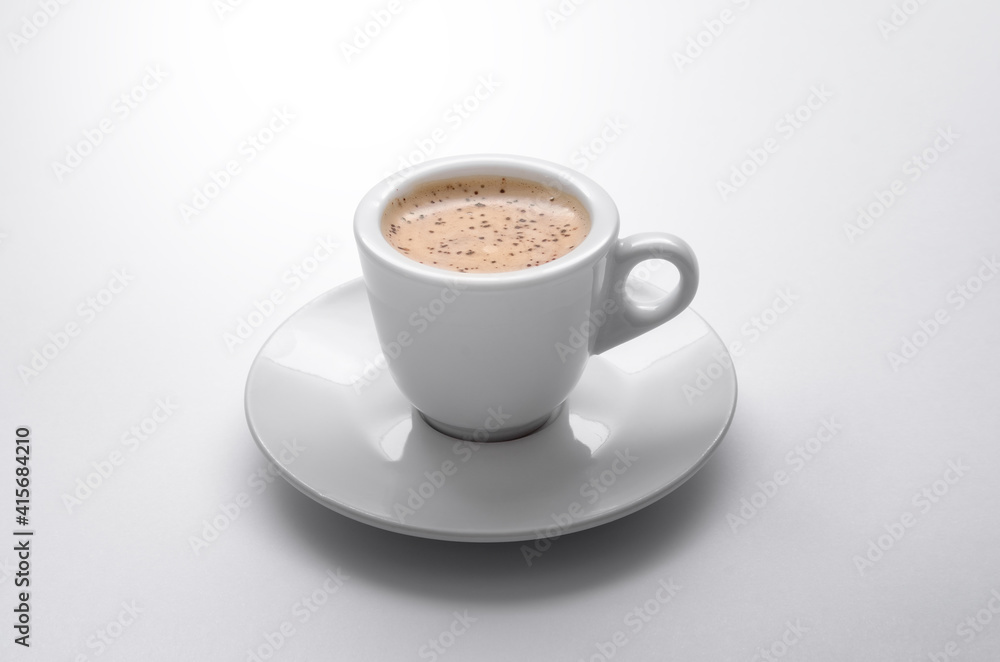 Aromatic coffee drink in white cup on white background Aromatic coffee drink in white cup on white background