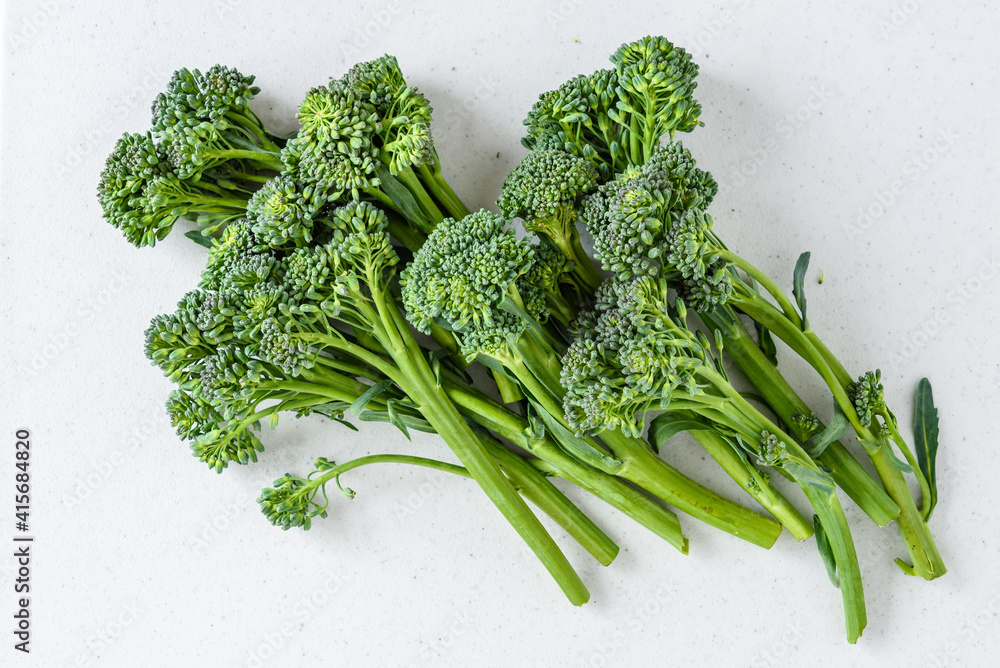Organic raw broccolini on a white cutting board, ready for roasting
Organic raw broccolini on a white cutting board, ready for roasting