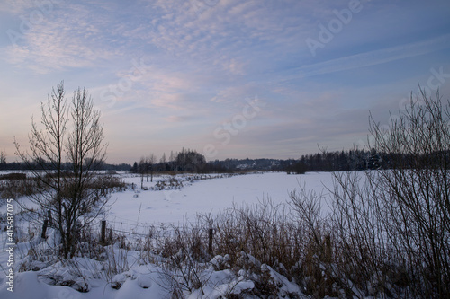 Landscape in winter scenery with sky in pastel colors.