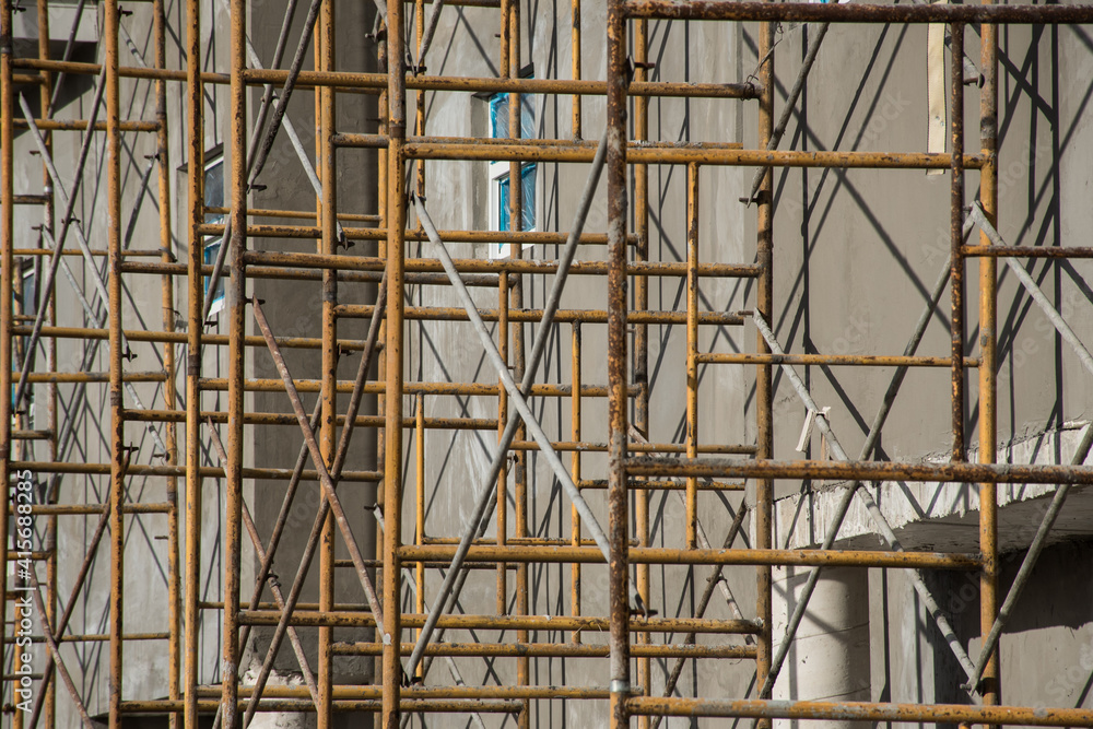 Scaffolding on the outside of a house under construction
Scaffolding on the outside of a house under construction
