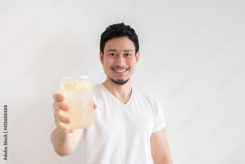 Asian man is drinking iced lemon soda on isolate white background. Asian man is drinking iced lemon soda on isolate white background.