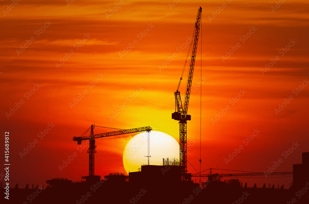 contruction site and crane and sunset contruction site and crane and sunset