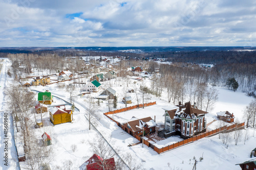 Aerial view of a cottage village in the snowy expanses of Siberia