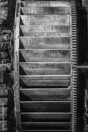Fototapeta Black and white of an old waterwheel of a gristmill, showing various layer of shade