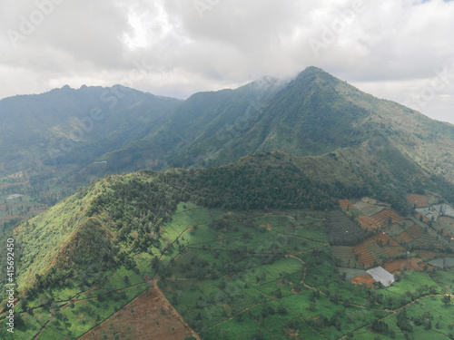 Aerial view of mountain valley with green scenery in Sindoro vulcano