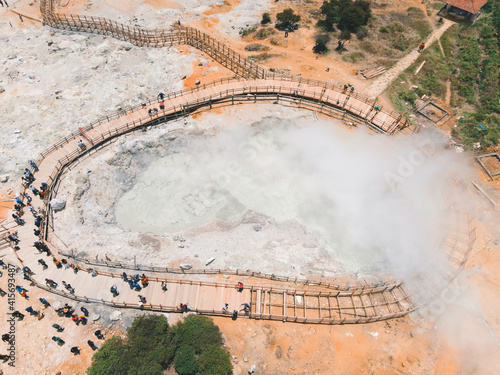 Aerial view of Sikidang crater with the background of sulfur vapor coming out of the sulfur marsh. photo