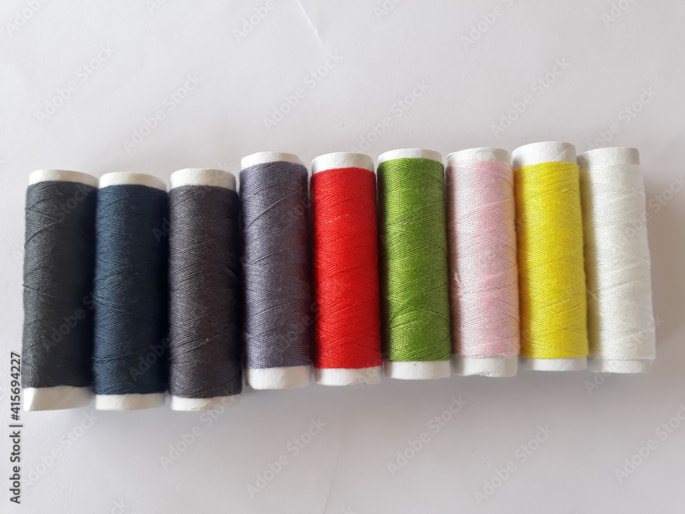 Rows of sewing threads of various colors Rows of sewing threads of various colors