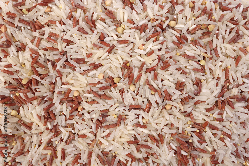 Mixed low glycaemic index healthy rice grain basmati millet buckwheat red rice heap on white background top view